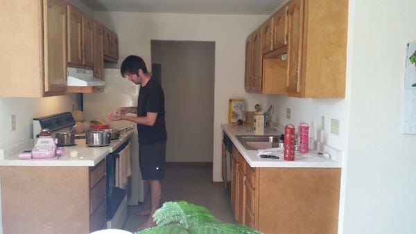 Kitchen in our new apartment - galley style with oak cabinets, older appliances, linoleum flooring