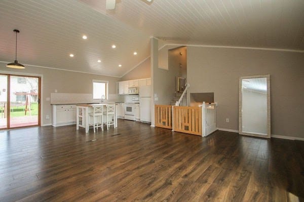 Our remodeled main floor - white plank ceiling, laminate wood flooring, subway tile backsplash, kitchen island, farmhouse sink, custom wood gates