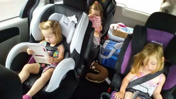 Kids in their car seats looking at tablets