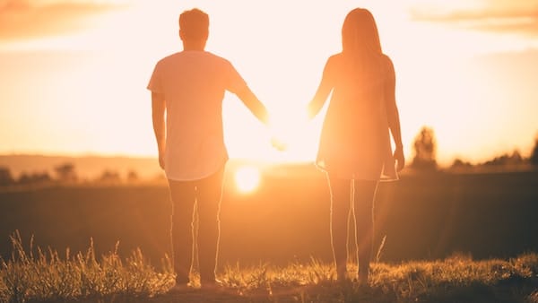 Couple watching sunset together