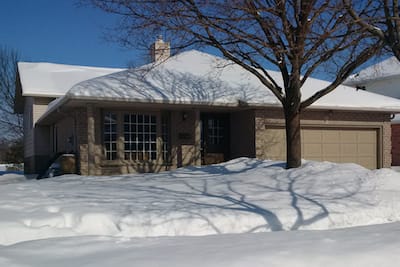 Picture of nice looking suburban home covered in snow