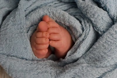 Baby feet sticking out of a blanket