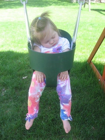 One of our girls asleep in a baby swing