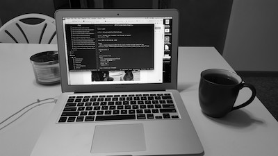 Laptop and coffee cup on table