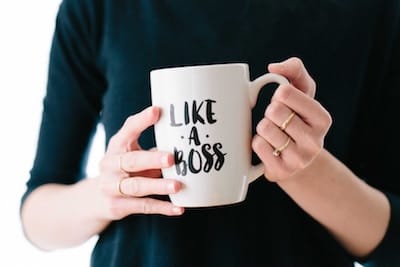 Woman holding mug with words "Like a Boss" on it