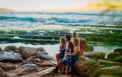 Our family on a beach in Hawaii, looking out into the distance 