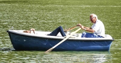 Elderly man rowing boat