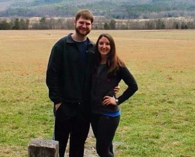 Jared and his girlfriend standing in a grassy field