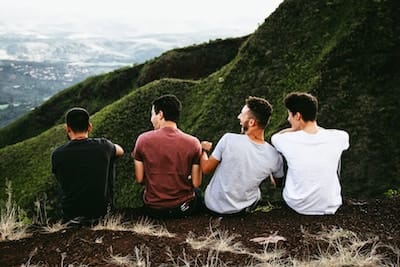 Friends joking and looking out over the mountains