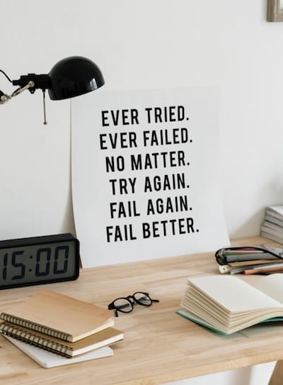 Sign on desk with words "Ever Tried. Ever Failed. No Matter. Try Again. Fail Again. Fail Better"