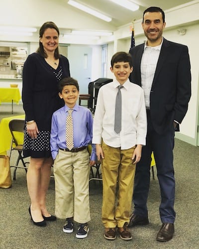 Laurie, her husband, and their sons in dress clothes