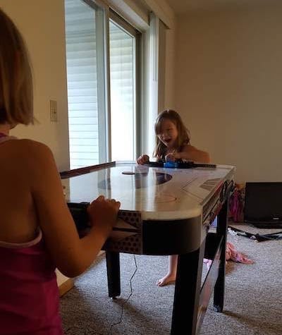 Girls playing on air hockey table