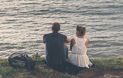 A couple relaxing by the water