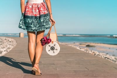 Girl walking on boardwalk at beach