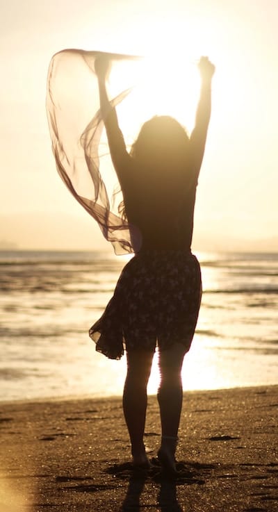 Woman celebrating on beach