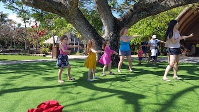 Jaime and the girls doing the hula in Hawaii