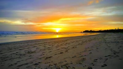 Sun setting over beach and ocean